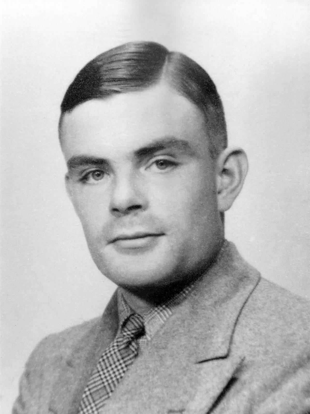 Black and white portrait photograph of Alan Turing