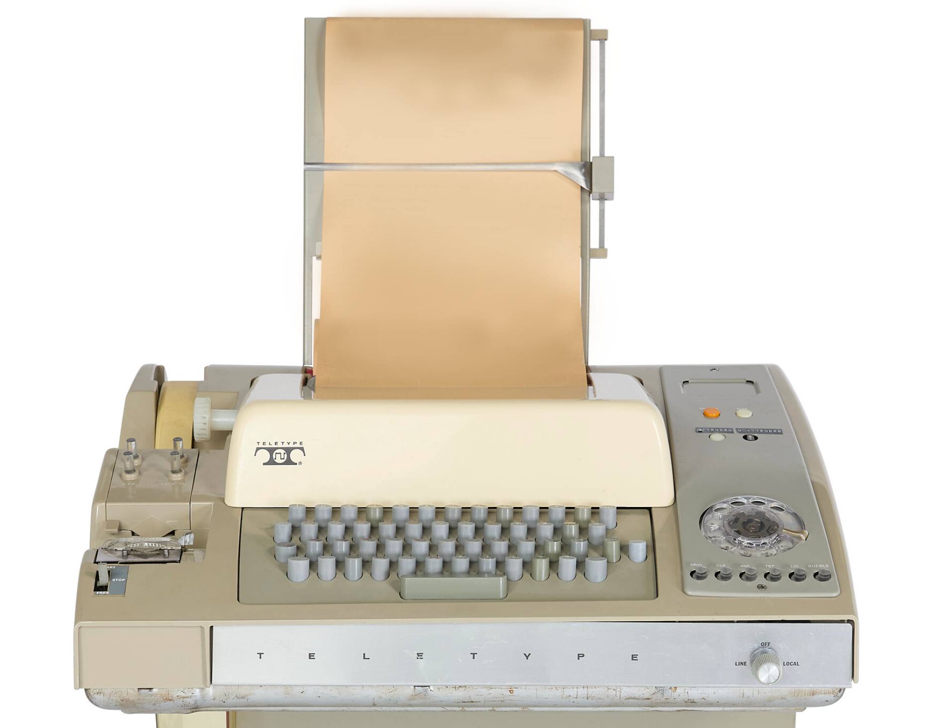 A vintage teletype machine with keyboard and paper roll