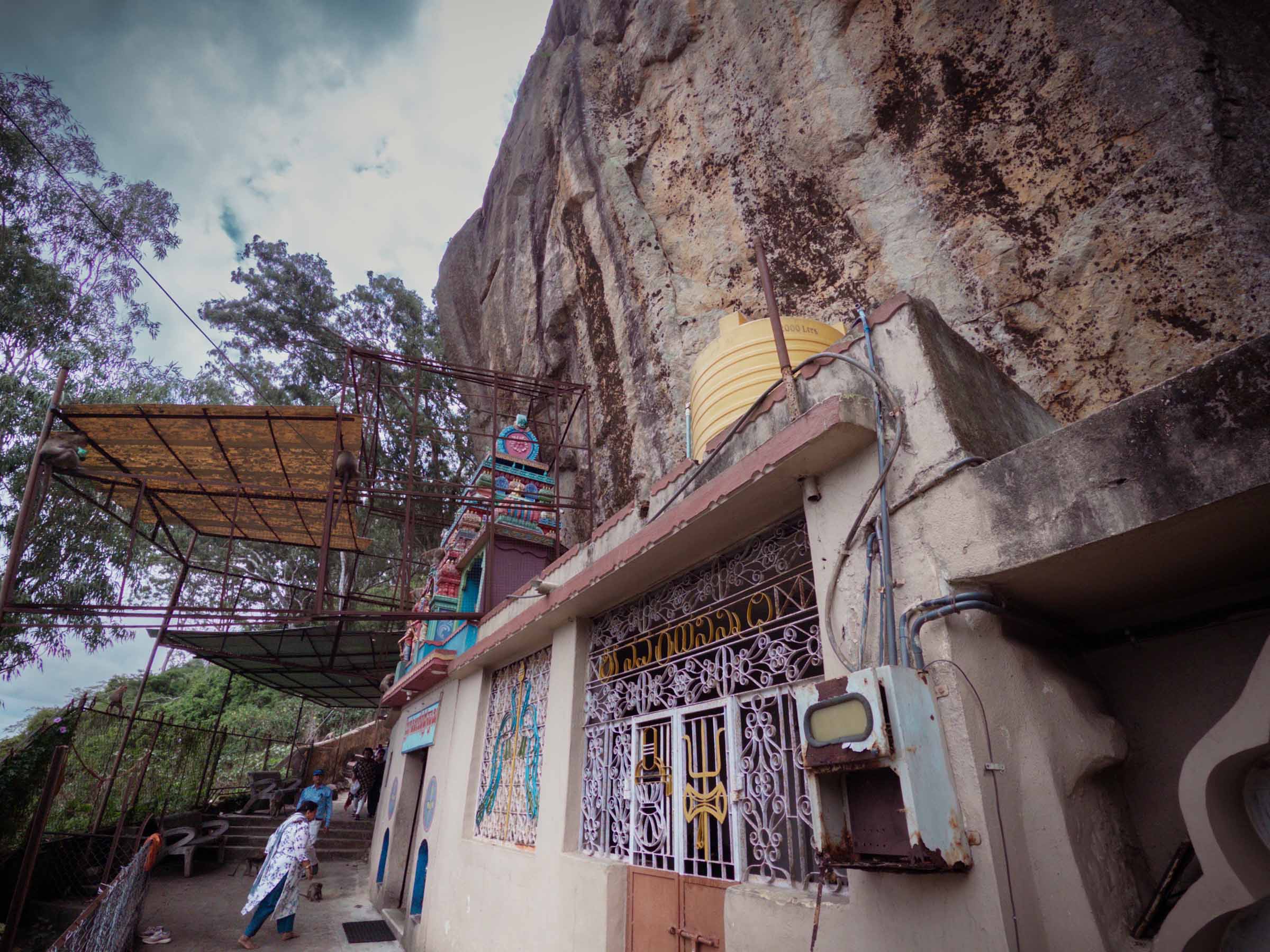 A small temple built against a sheer granite cliff