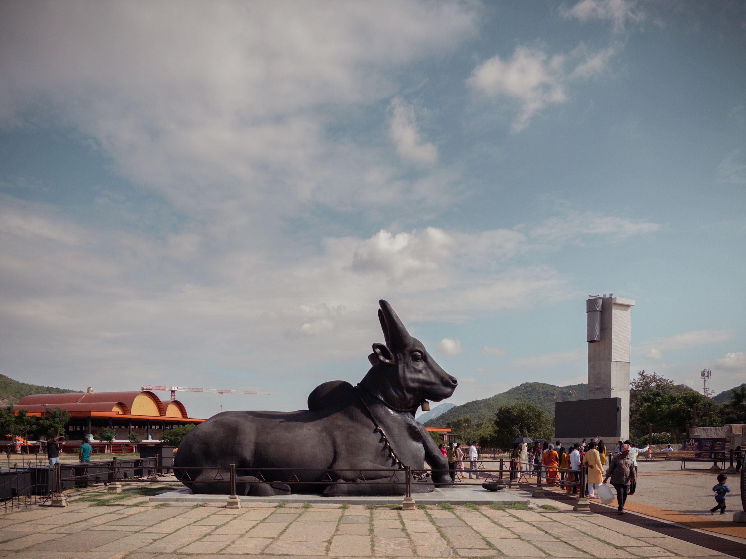 A giant black statue of Nandi the bull reclining in the plaza