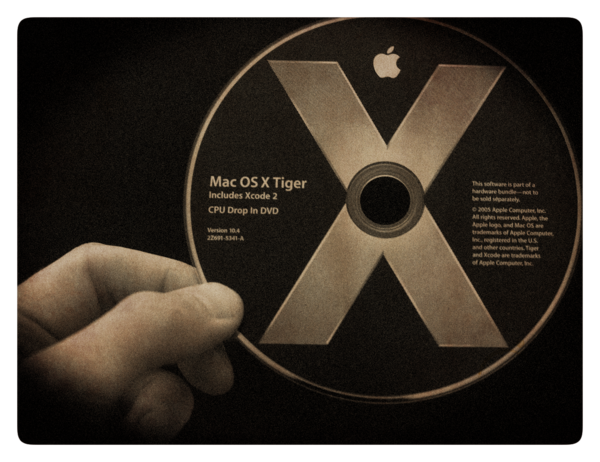 image of hand holding Mac OS X Tiger DVD