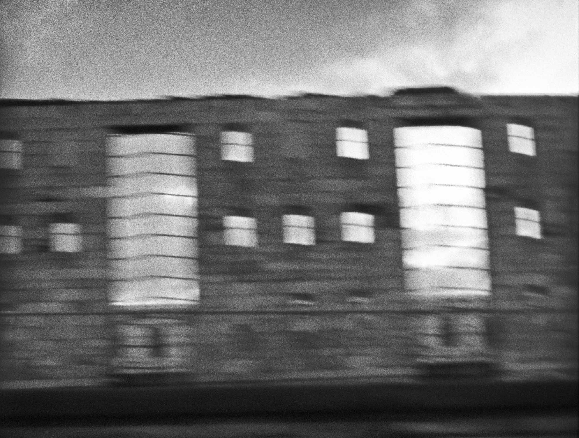 Blurry, dark black-and-white photo of Sing Sing's gutted old cell block.